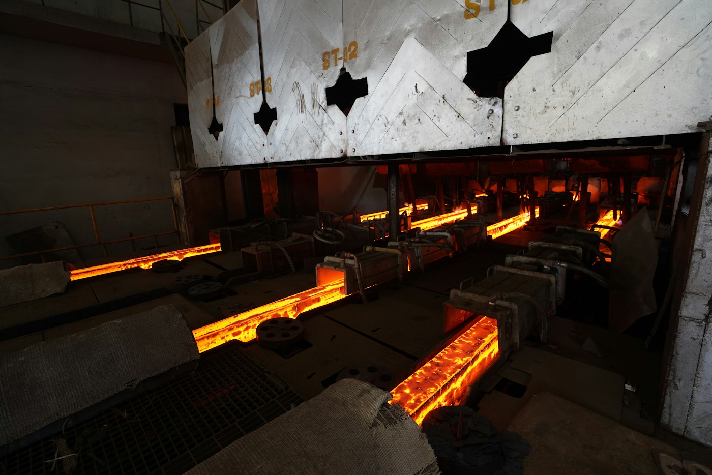 Hot steel moving through a modern production line; illustrative industry photograph